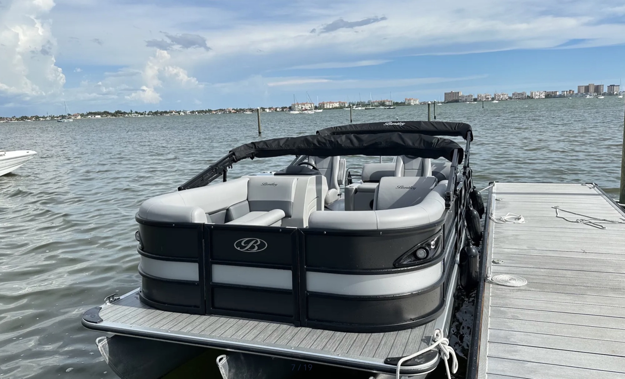 Front view of the Bentley tritoon docked beside open water