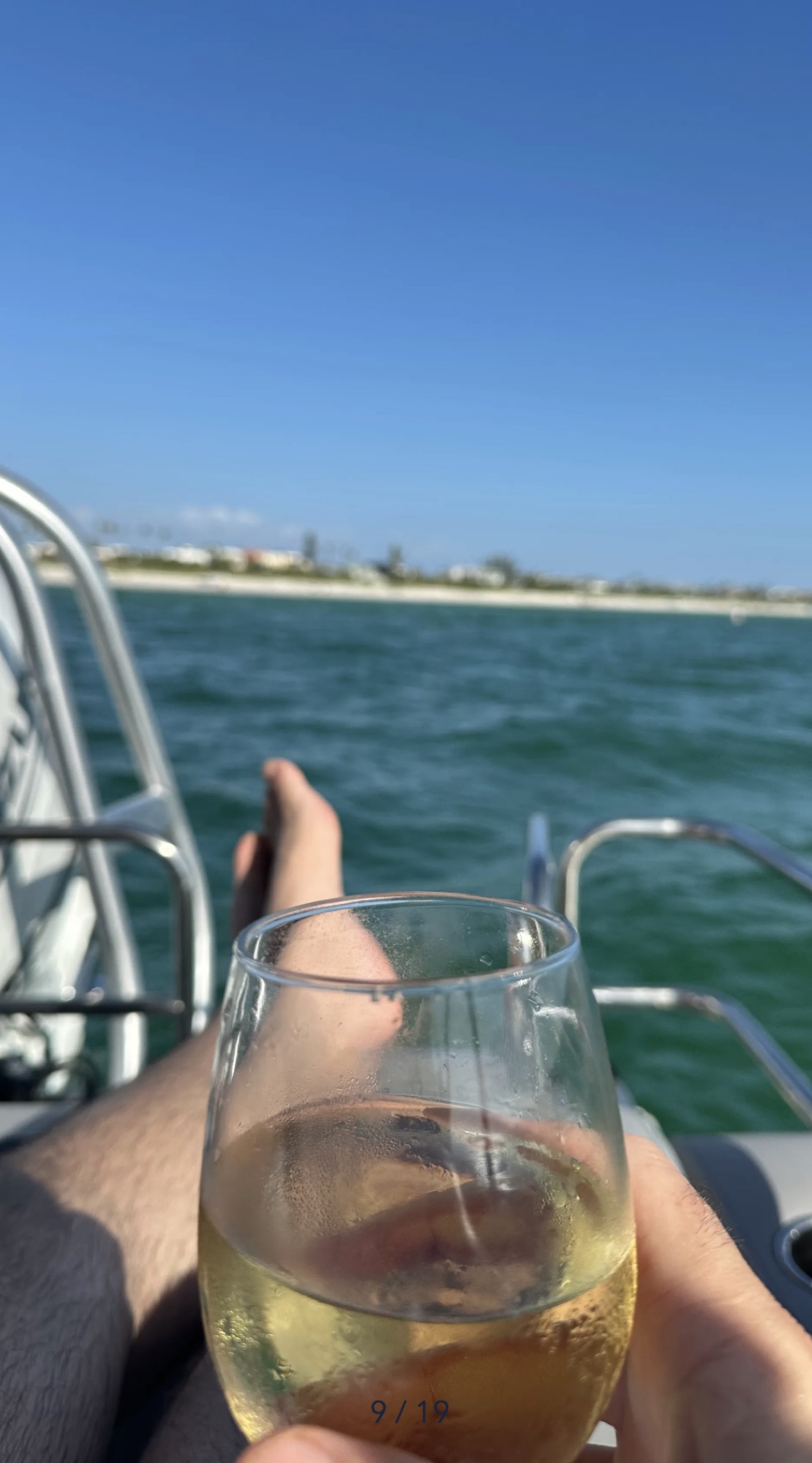 Relaxing boat-day view with a drink and turquoise water