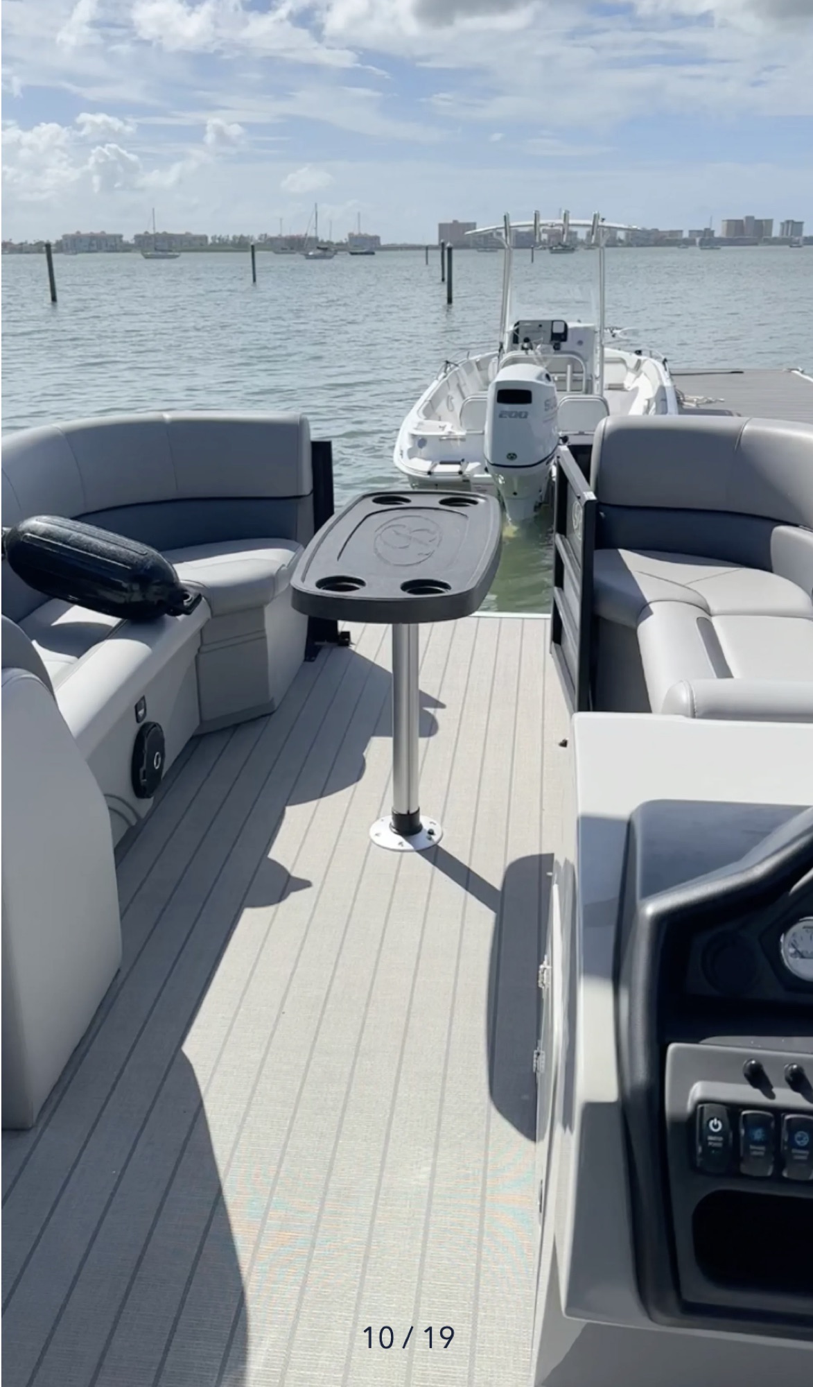 Open Bentley tritoon walkway, table, seating, and helm
