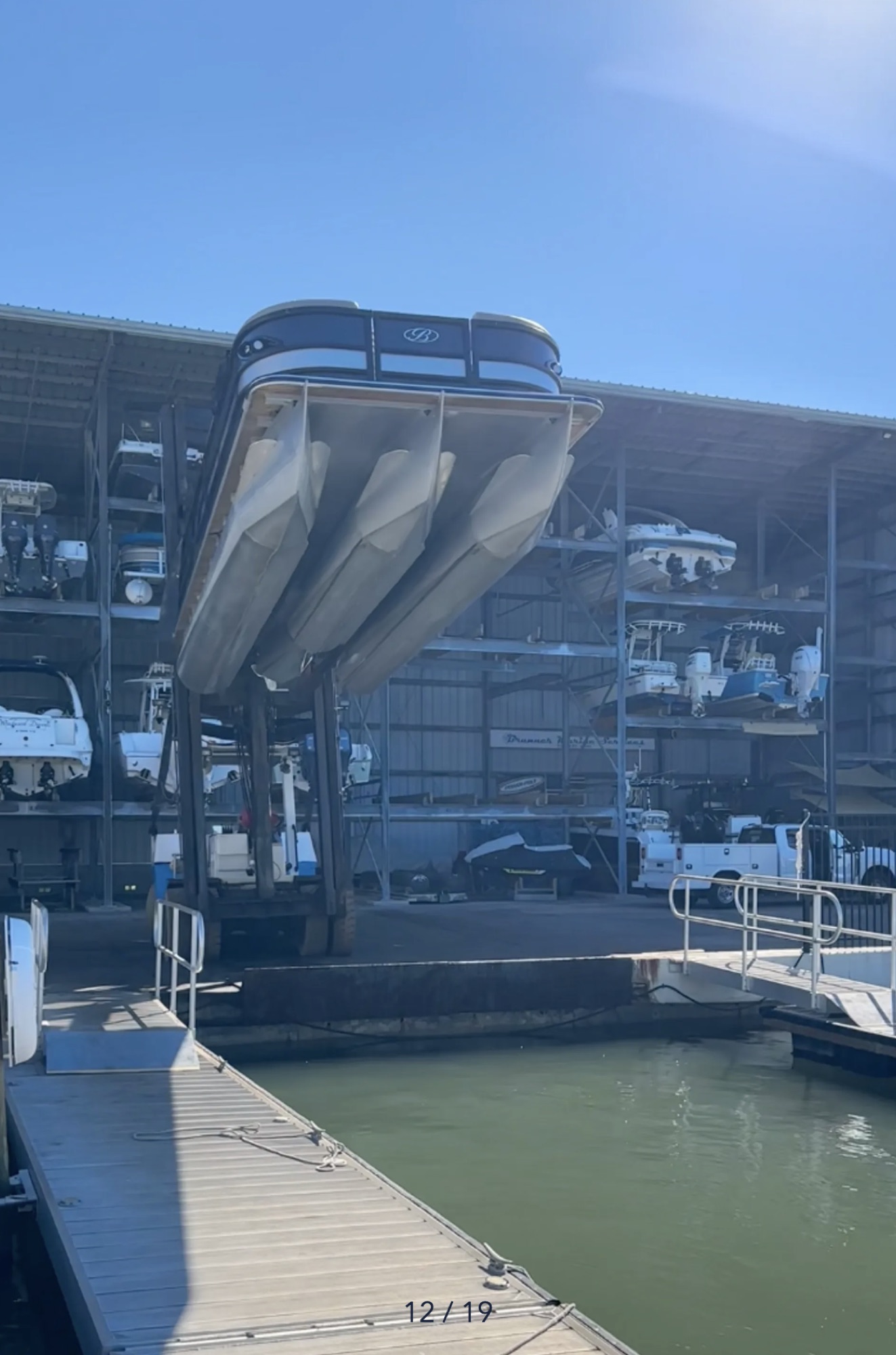 Bentley tritoon lifted above the marina showing its three pontoons