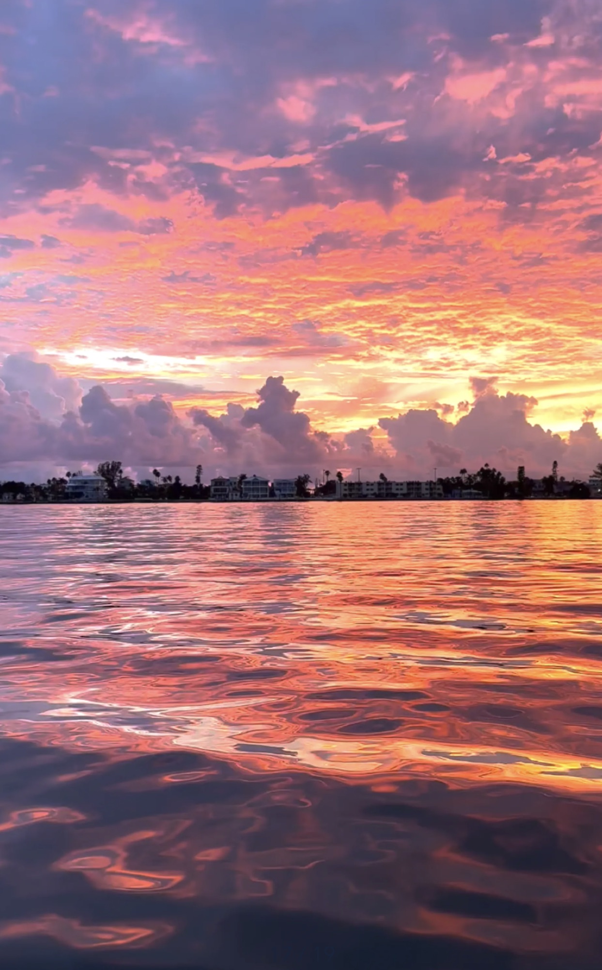 Vivid pink and orange sunset reflected across St. Petersburg water